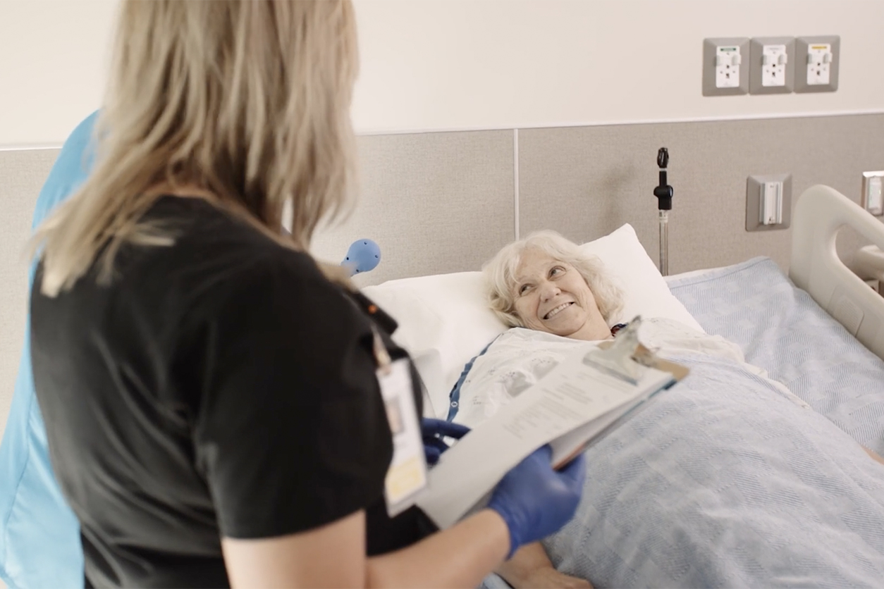 new mother in hospital gown embraces her baby